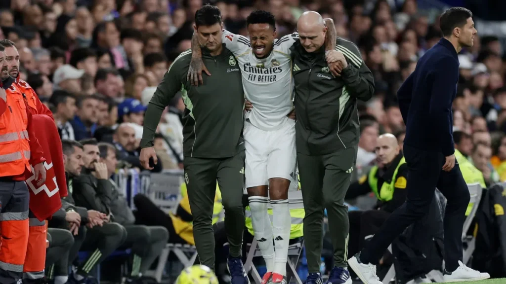 Éder Militão sai de campo com auxílio dos médicos do Real Madrid. Foto: Maria Gracia Jimenez/Soccrates/Getty Images